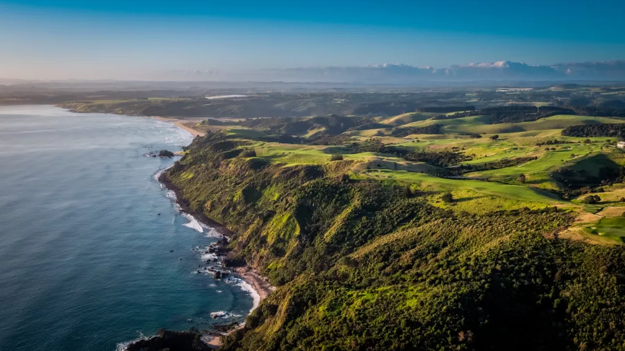 Aerial view of Kauri Cliffs Golf Course stretching along the rugged coastline of the Bay of Islands, New Zealand