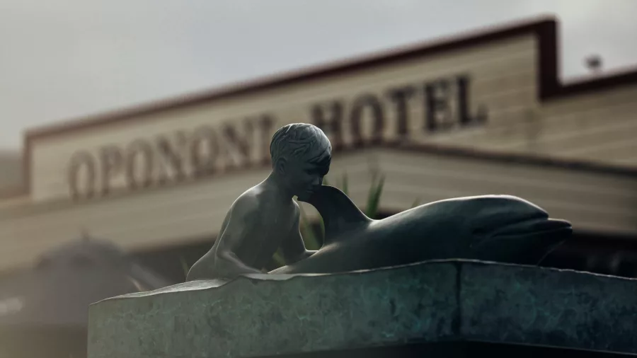 Statue of Opo the Dolphin and child outside the Opononi Hotel in Hokianga