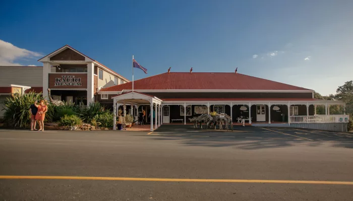 Exterior view of The Kauri Museum with red roof and colonial-style verandah in Matakohe