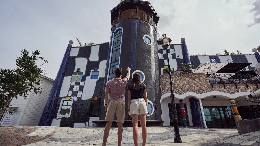 Couple pointing at architectural details of the Hundertwasser Art Centre in Whangārei