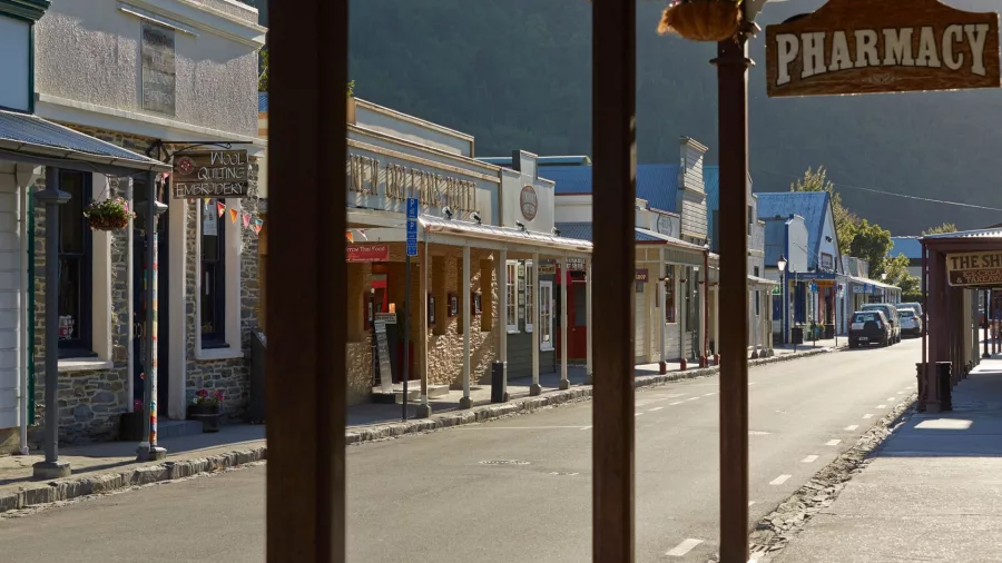 Arrowtown’s main shopping street in the early morning with sunlight casting long shadows.