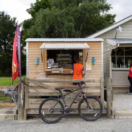 Bicycle parked outside a country stall in Hyde on the Otago Central Rail Trail