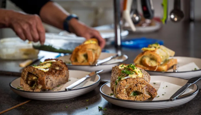 Cheese roll being sliced at Lauder Stationside Café on the Otago Central Rail Trail