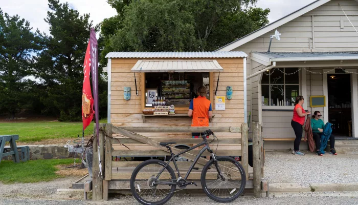 Bicycle parked outside a country stall in Hyde on the Otago Central Rail Trail