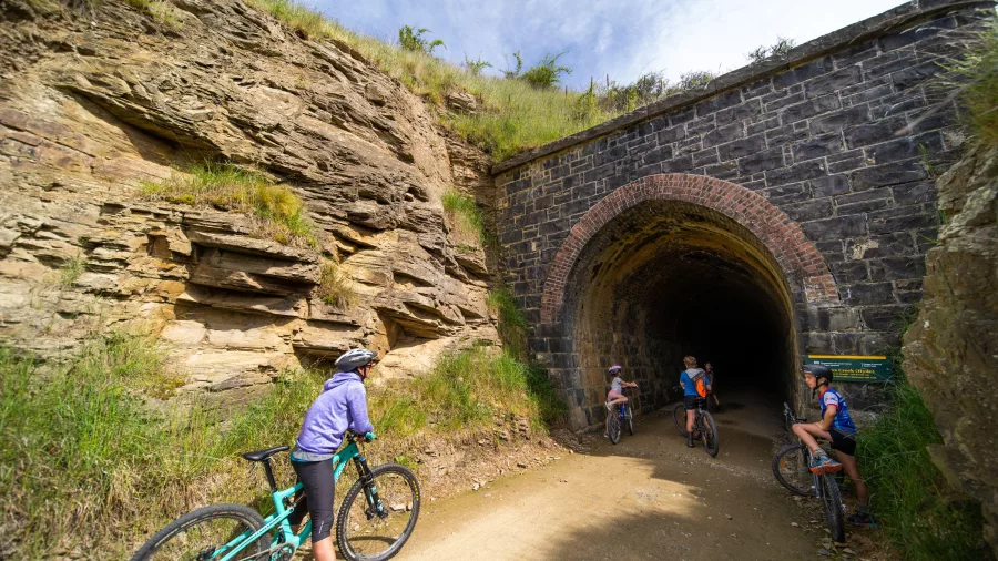 Trail users pausing at tunnel entrance on the Otago Central Rail Trail
