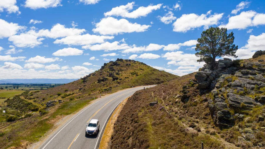 Car driving on Central Otago Touring Route near Omakau towards Chatto Creek