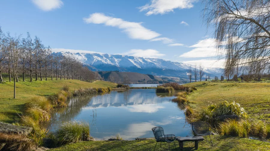 Scenic view of the Clutha River and snow-capped mountains from Cloudy Bay Shed in Cromwell, Central Otago, New Zealand