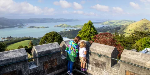 Mother and child enjoying views over Otago Harbour from Larnach Castle’s tower.