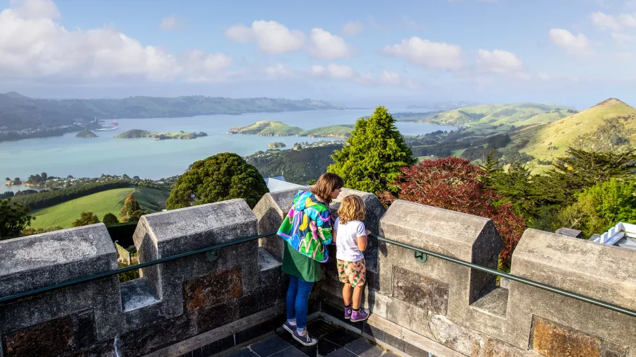 Mother and child enjoying views over Otago Harbour from Larnach Castle’s tower.