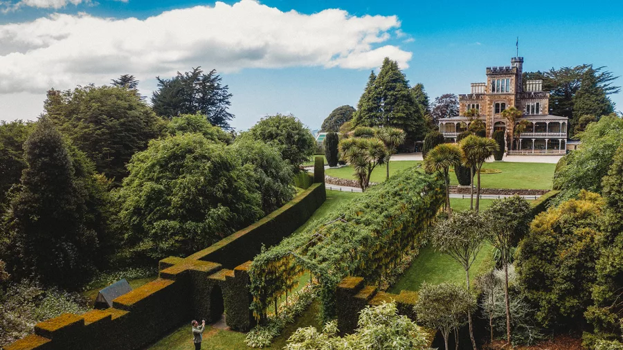 Elevated view of the lush gardens surrounding Larnach Castle in Dunedin.