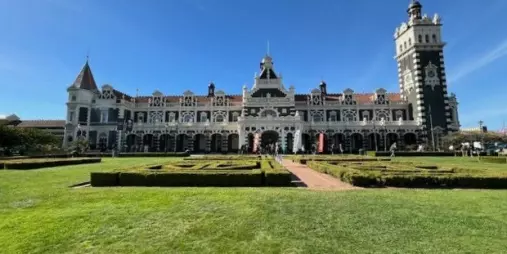 Wide view of Dunedin’s iconic railway station with its Flemish renaissance architecture.