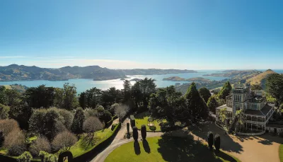 Panoramic aerial view of Larnach Castle and Gardens on the Otago Peninsula with Otago Harbour in the background, Dunedin, New Zealand