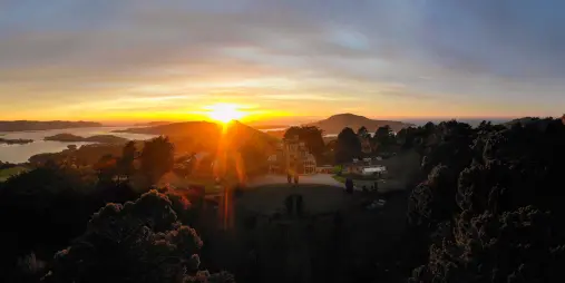 Sunrise over Larnach Castle on the Otago Peninsula with panoramic views across Otago Harbour in Dunedin, New Zealand