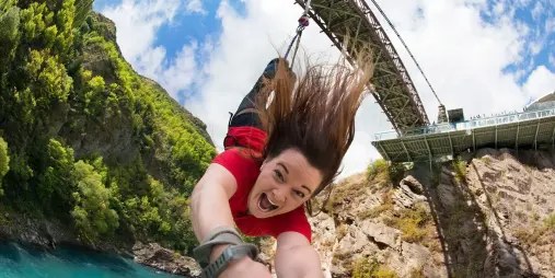 Female jumping from the Kawarau Bridge Bungy in Queenstown
