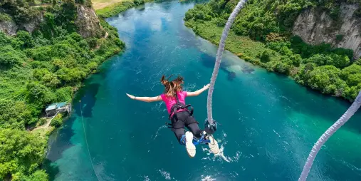 Female enjoying the Taupō Bungy above the Waikato River
