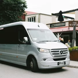 A luxury Mercedes-Benz van parked outside The Winery in Arrowtown, part of a Queenstown gin tour.