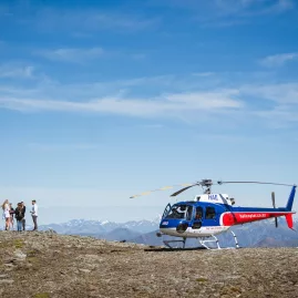 Helicopter landing on remote mountain for Queenstown wine tour