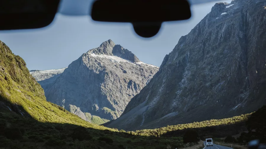 View of the dramatic Fiordland mountain landscape from a tour vehicle on Milford Road