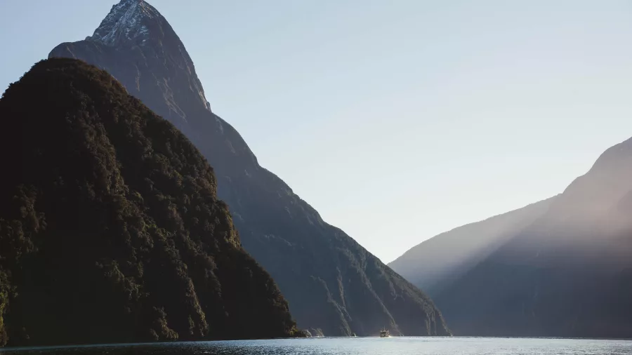 Mitre Peak silhouetted against the morning sun in Milford Sound