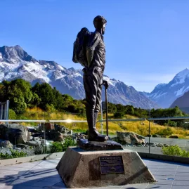 Statue of Sir Edmund Hillary facing Aoraki Mount Cook with Southern Alps in the background.