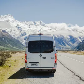 Premium tour van on the scenic highway leading into Mount Cook National Park.