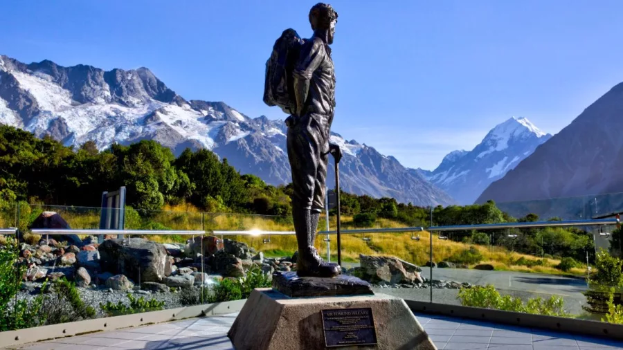 Statue of Sir Edmund Hillary facing Aoraki Mount Cook with Southern Alps in the background.