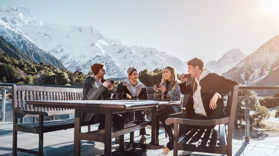 Tour group enjoying lunch outdoors at The Hermitage with snowy mountain views.