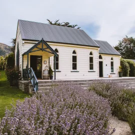 The Church at Waitiri Creek surrounded by lavender gardens and vineyard hills, used as a wine tasting venue near Queenstown