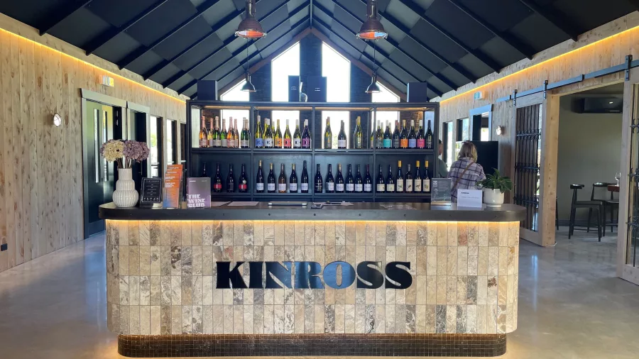 Kinross cellar door interior with a modern tasting bar and bottles on display in Gibbston Valley