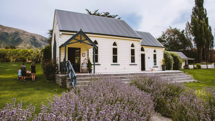 The Church at Waitiri Creek surrounded by lavender gardens and vineyard hills, used as a wine tasting venue near Queenstown