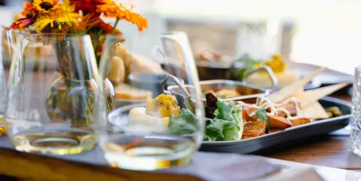 Wine and food tasting platter with white wine glasses