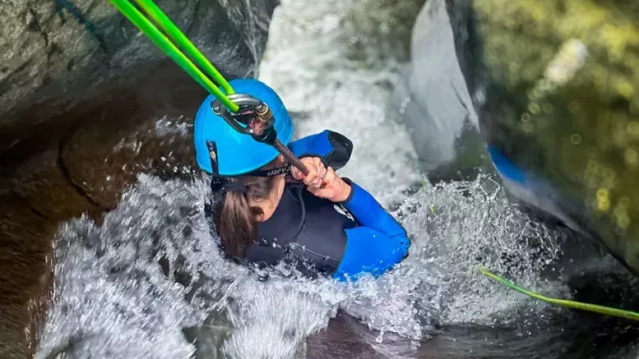 Canyoner descending steep chute using ropes in Gibbston Valley