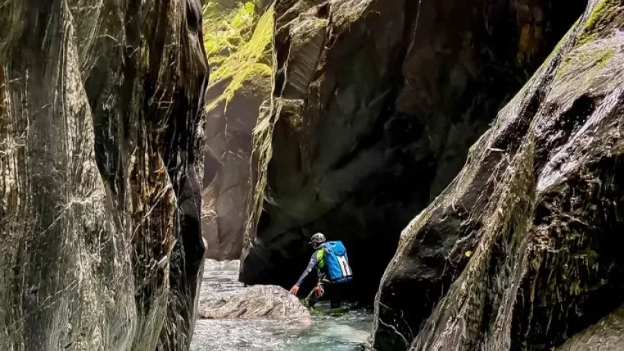 Adventurer hiking through narrow canyon in Mt Aspiring Max