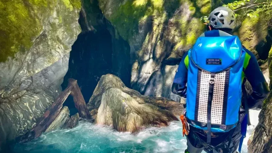 Canyoner overlooking powerful canyon stream