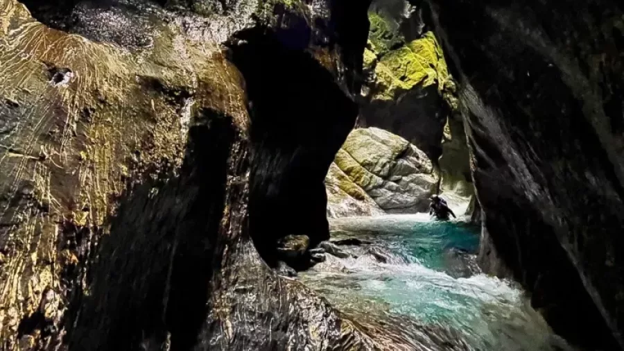 Dark, narrow canyon passage with rock textures