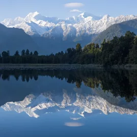 Lake Matheson is famous for its mirror-like reflections of Aoraki / Mount Cook — a photographer’s dream near Franz Josef.