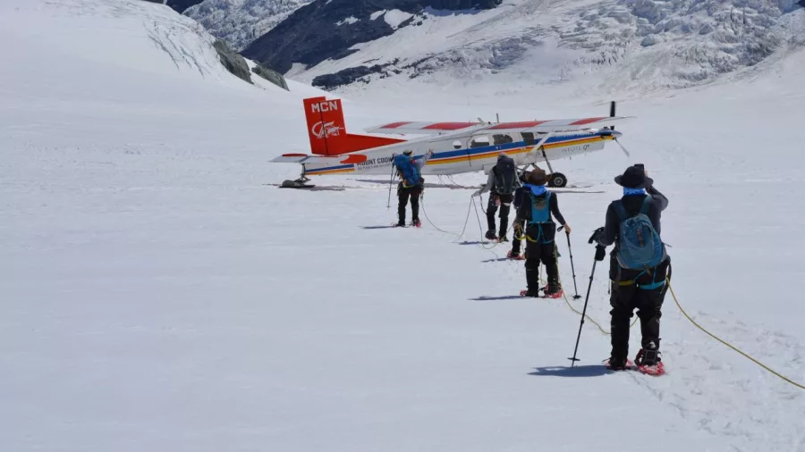 Tour group preparing for a snow landing experience near Mount Cook by ski plane