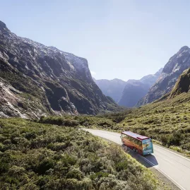 Scenic coach driving through Eglinton Valley en route to Milford Sound.