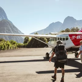 Glenorchy Air plane preparing for take off with a backdrop of Mitre Peak.