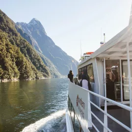 Passengers enjoying the view of Mitre Peak aboard a Southern Discoveries boat in Milford Sound.