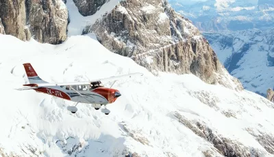 Glenorchy Air scenic flight soaring above snow-covered peaks in the Southern Alps