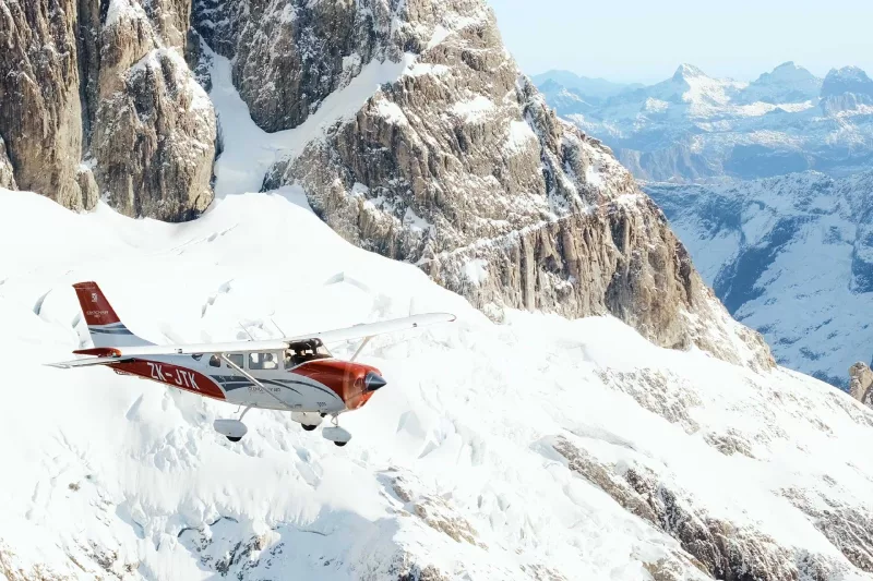 Glenorchy Air scenic flight soaring above snow-covered peaks in the Southern Alps