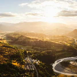 Aerial view of Shotover River winding through golden valleys at sunrise