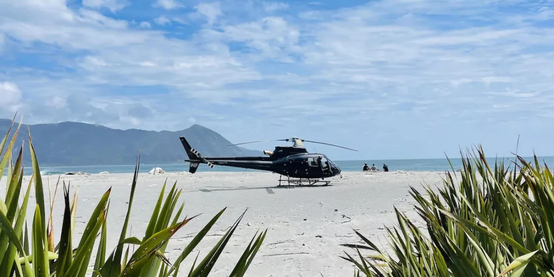Helicopter landed on remote West Coast beach during Milford Alps to Ocean tour