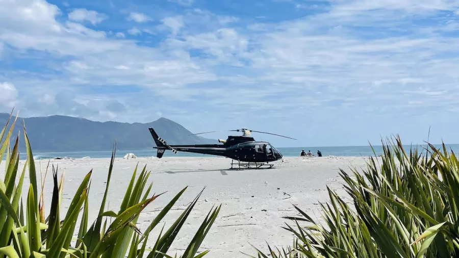 Helicopter landed on remote West Coast beach during Milford Alps to Ocean tour