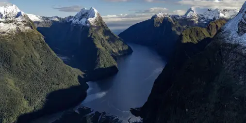 Aerial view of Milford Sound and Fiordland mountains at sunset