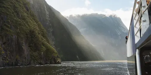 Passengers taking in the view from a cruise boat on Milford Sound