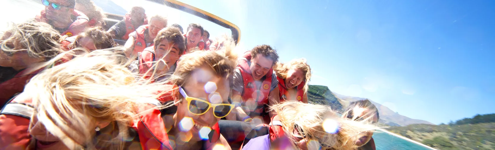 Excited passengers on a high-speed KJet boat ride in Queenstown