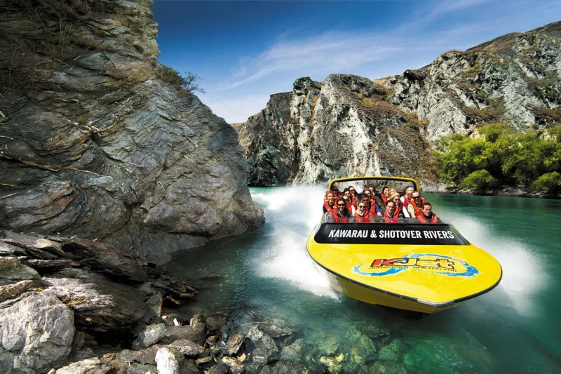 KJet jet boat powering through narrow canyon walls on the Shotover River