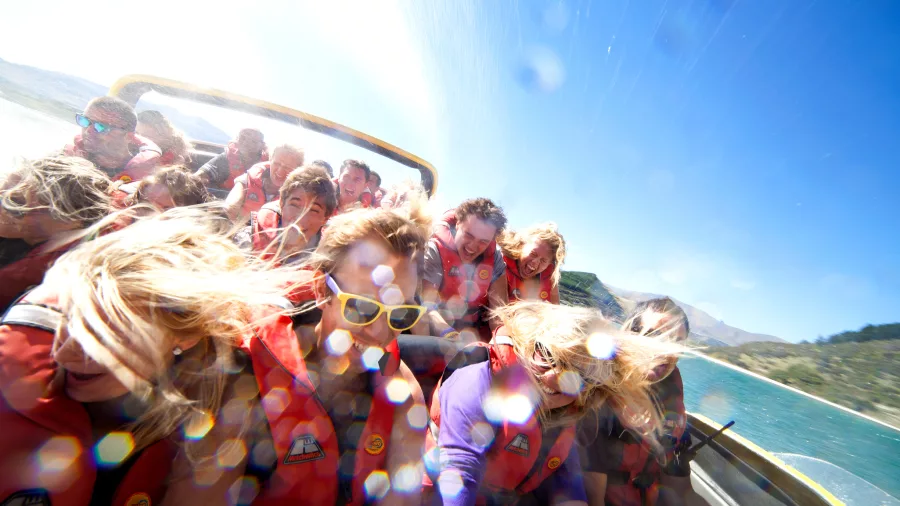 Excited passengers on a high-speed KJet boat ride in Queenstown